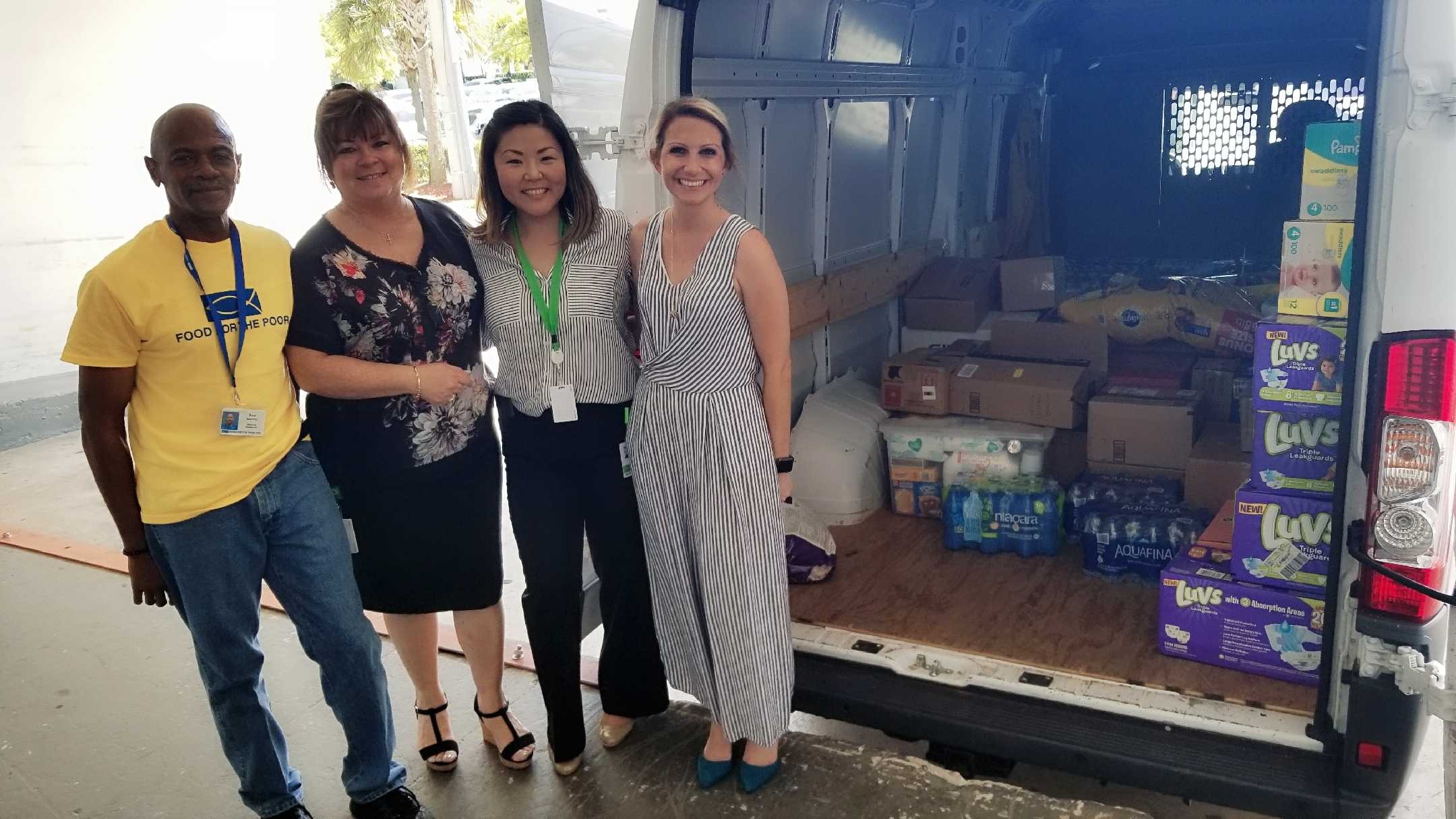 Fred from Food For The Poor with Cruise Planners' Mirna from Special Programs and Fumi and Jackie from People and Culture